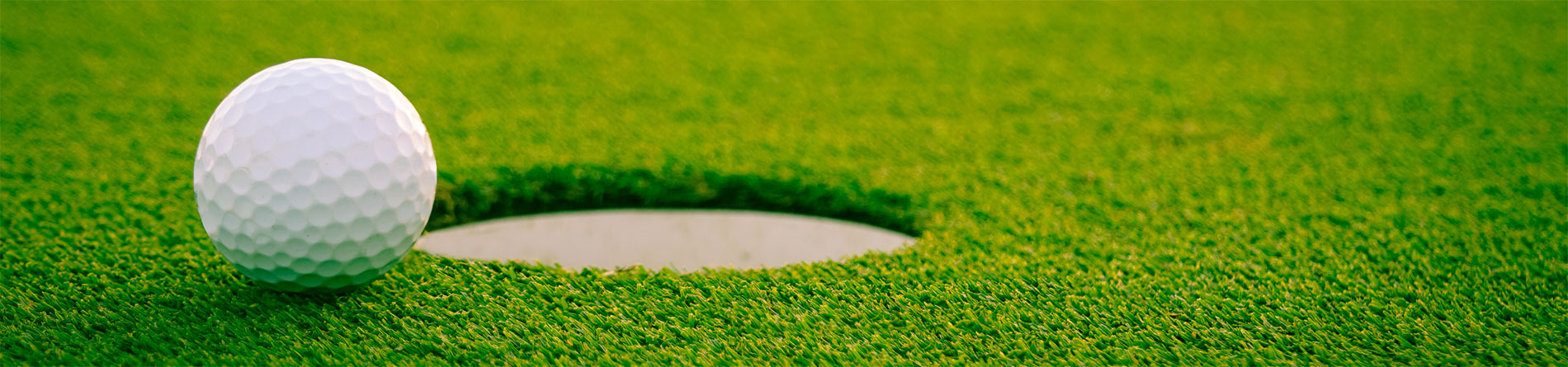 golf ball near a hole on the course